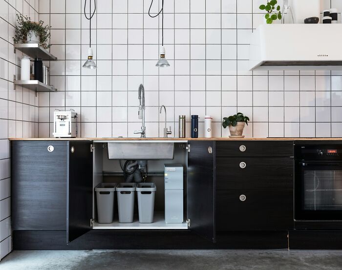 Under sink water filtration system in modern kitchen cabinet