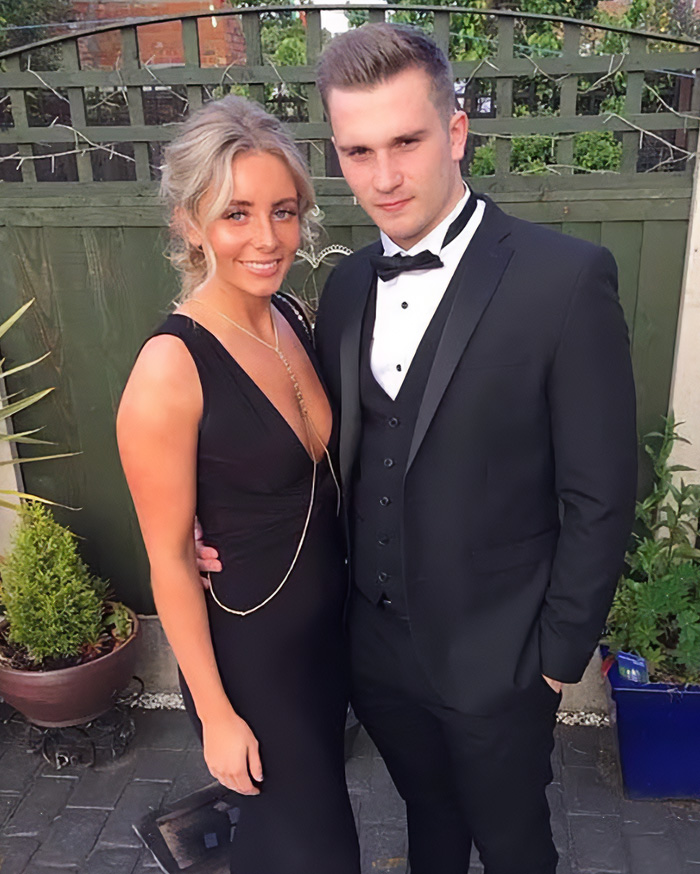 Couple dressed formally posing outdoors at event