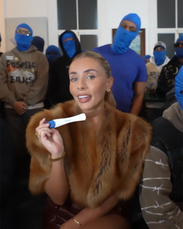 Pregnant woman holding a pregnancy test at a baby shower drama