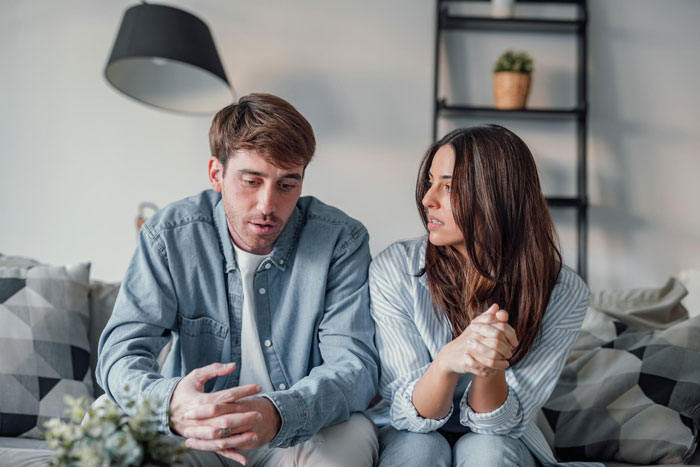 Couple sitting and having a serious conversation about relationship problems Couple sitting and having a serious conversation about relationship problems