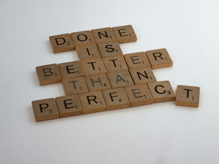 Scrabble tiles spelling done is better than perfect thought pattern