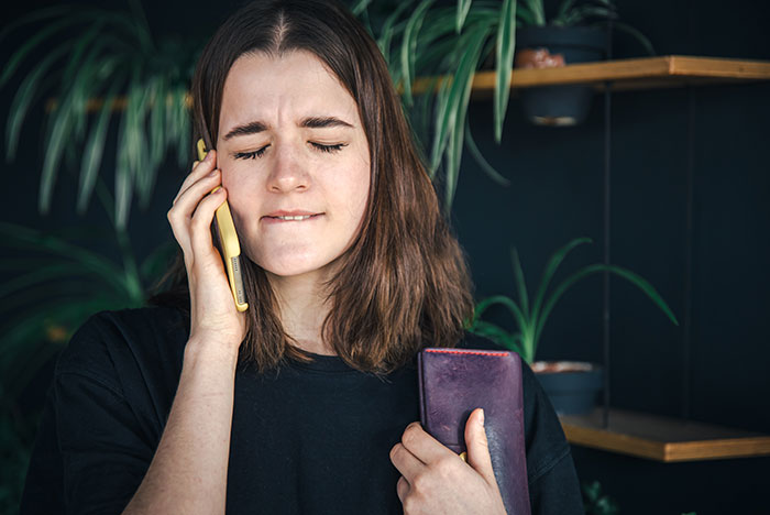 Stressed bride on phone reflecting on big wedding mistake and giving advice to engaged couples Stressed bride on phone reflecting on big wedding mistake and giving advice to engaged couples