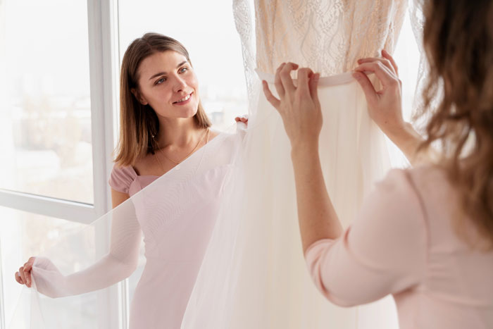 Bride and sister discussing wedding dress choice Bride and sister discussing wedding dress choice