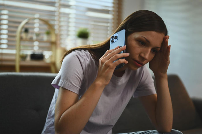 Stressed woman talking on phone at home Stressed woman talking on phone at home