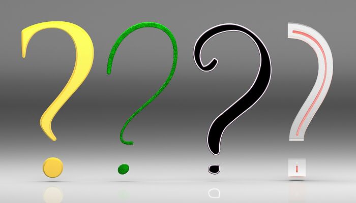 Four different colored question marks, symbolizing the diverse general knowledge questions in a pub quiz.