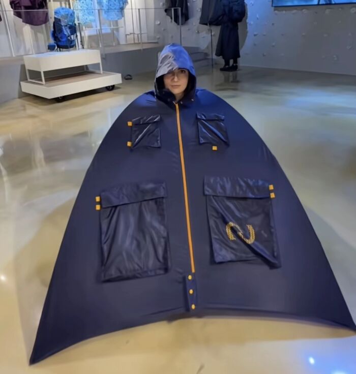 A woman inside a large, bizarre, tent-like garment, an image raising many questions about its purpose.