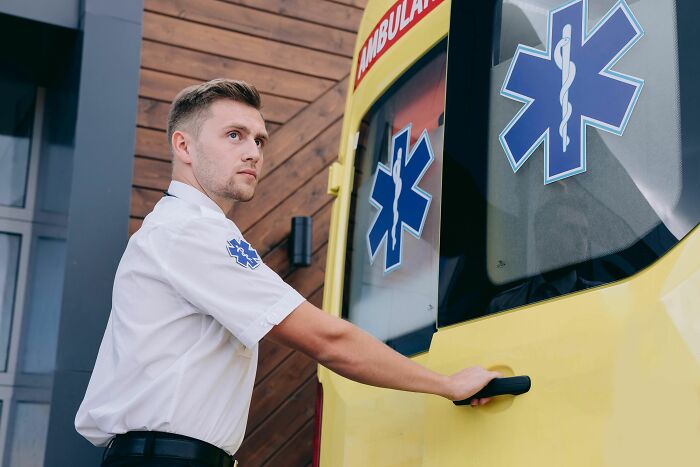 Paramedic opening ambulance door ready for emergency response
