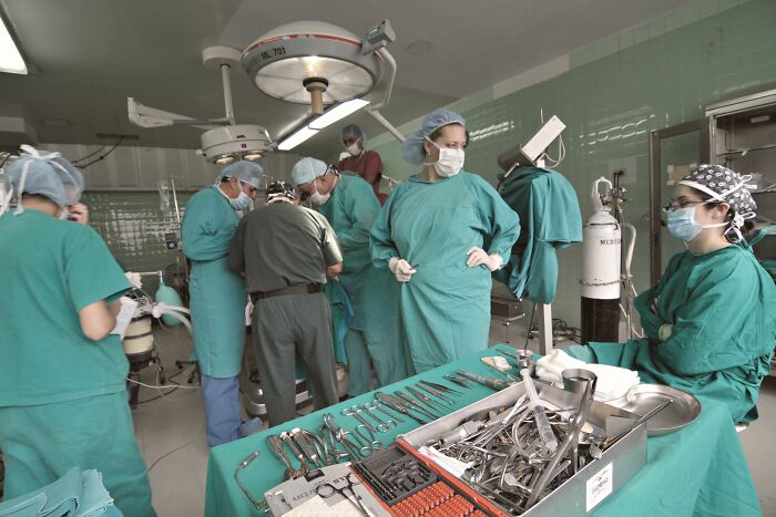 Medical team in operating room with surgical instruments