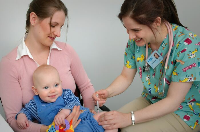 Nurse giving an injection to a baby, highlighting important health trends and preventing intense stress.