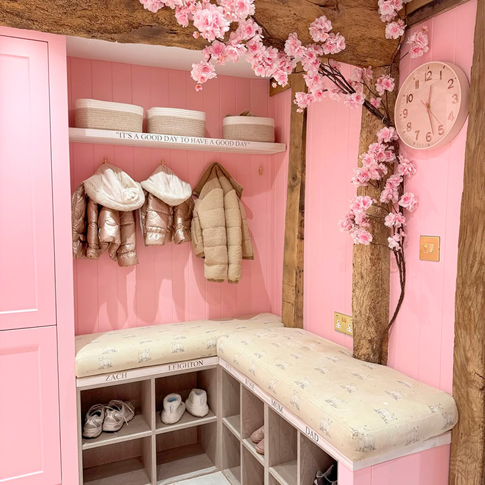 A pink-themed entryway with cherry blossom decor, built-in benches, and cubbies, an example of questionable renovations that devalued homes. A pink-themed entryway with cherry blossom decor, built-in benches, and cubbies, an example of questionable renovations that devalued homes.