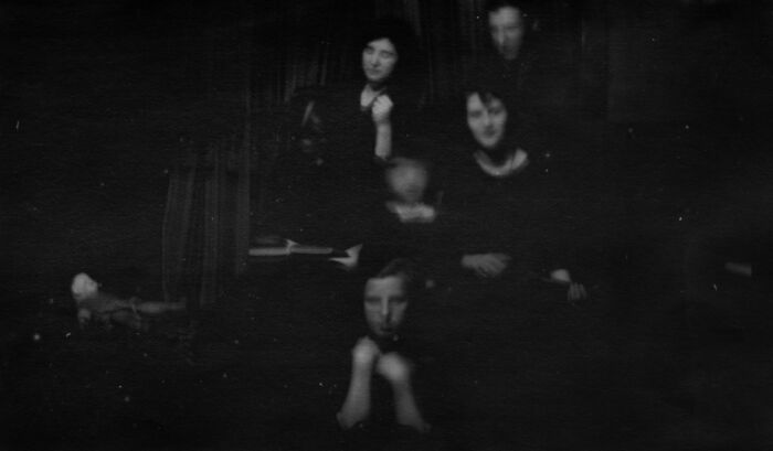 Historical photos of a haunting family portrait with multiple figures overlaid, creating an impossible explanation.