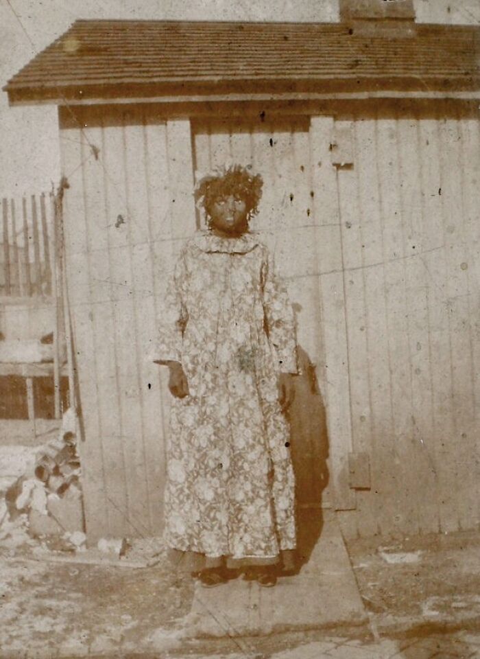 A child with curly hair in a floral dress stands outdoors, part of a collection of historical photos.