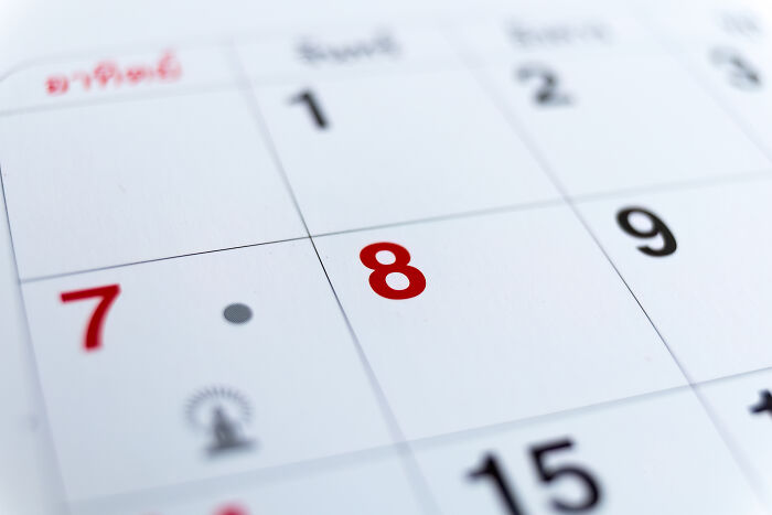 A close-up of a calendar page with the number 8 highlighted in red, signifying wild coincidences.