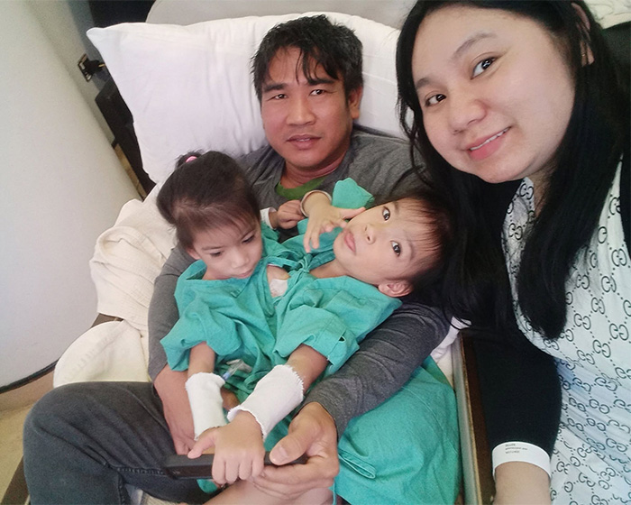 Parents hold their 2-year-old conjoined twins, who are recovering from successful separation surgery. Parents hold their 2-year-old conjoined twins, who are recovering from successful separation surgery.