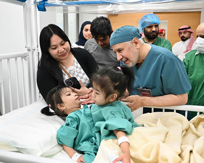 A doctor consults with the mother of 2-year-old conjoined twins after their successful separation surgery. A doctor consults with the mother of 2-year-old conjoined twins after their successful separation surgery.