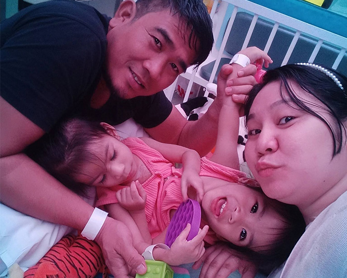Happy family with conjoined twins, who were successfully separated after grueling surgery, smiling together. Happy family with conjoined twins, who were successfully separated after grueling surgery, smiling together.