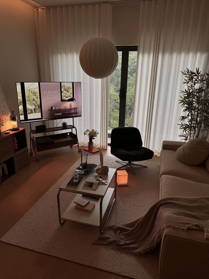 Dark cozy living room with modern furniture and soft lighting in cool interior design style
