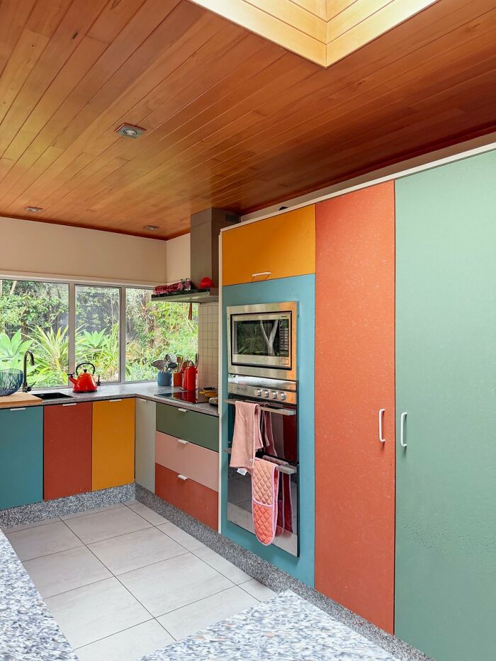 Colorful kitchen cabinets and granite countertops featuring vibrant cool interior design ideas