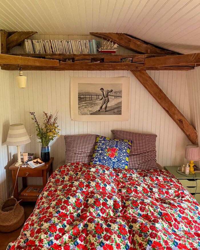 Cozy bedroom with rustic beams and vibrant floral bedding showcasing cool interior design