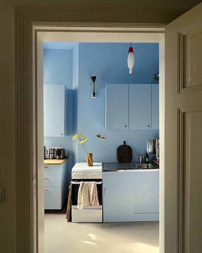 Compact blue kitchen with minimalist design in cool interior space