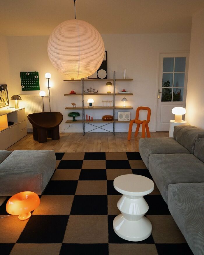 Modern living room with cool interior design and checkered rug under unique lighting fixtures