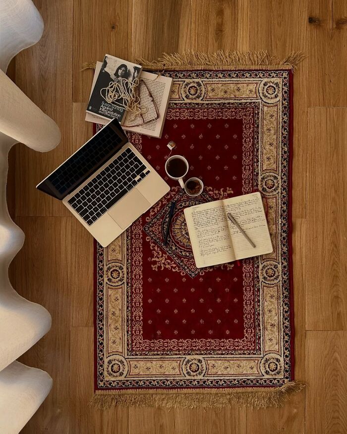 Workspace setup on red patterned rug reflecting creative interior design ideas