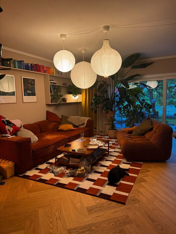Warm living room with brown sofas and hanging lanterns interior design concepts