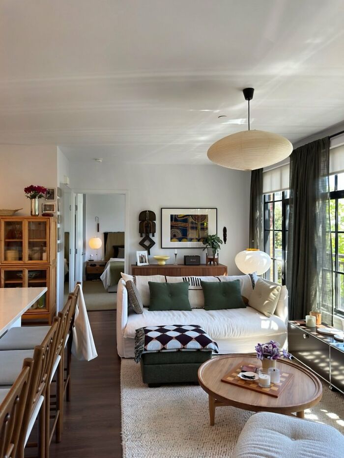 Bright living room interior design with natural light and neutral sofa