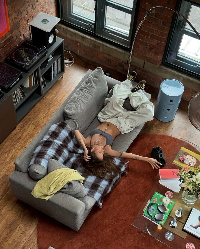 Cozy loft interior design with industrial brick walls and modern sofa decor
