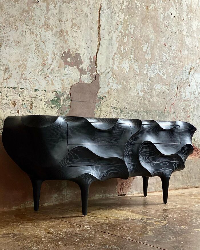 Black sculptural wooden cabinet as a unique cool interior design furniture piece