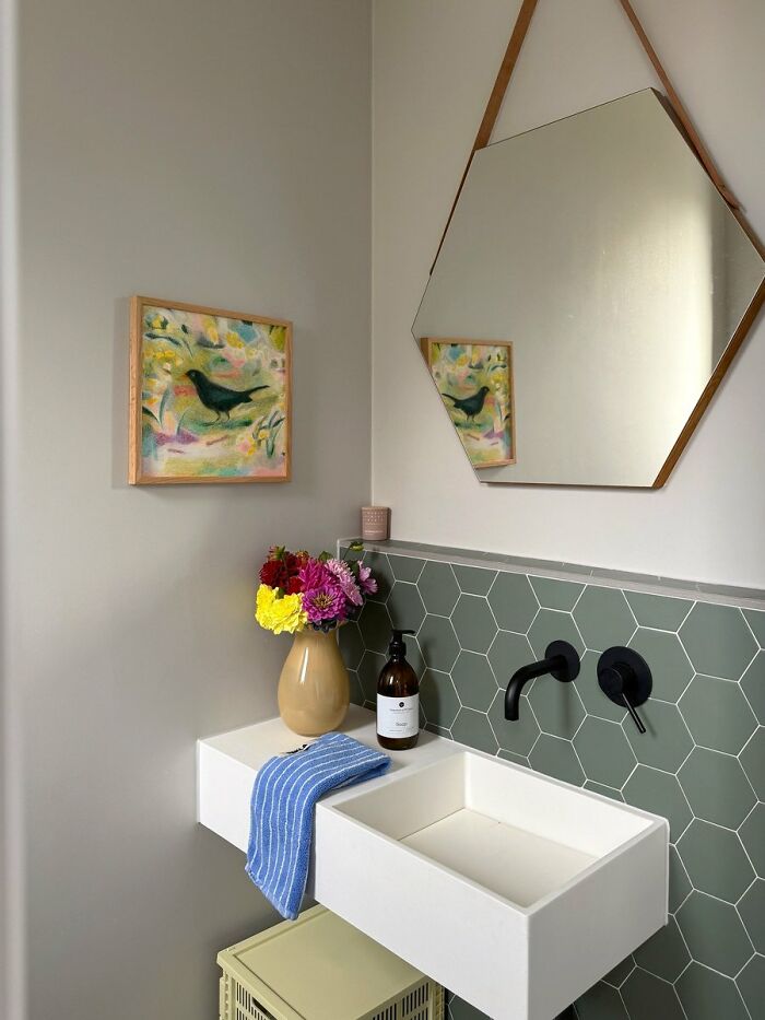 Minimalist bathroom with hexagonal tile backsplash and modern sink design