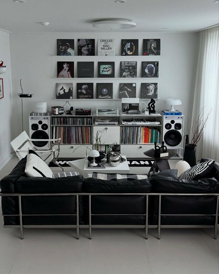 Minimalist living room with black leather sofa and vinyl record display