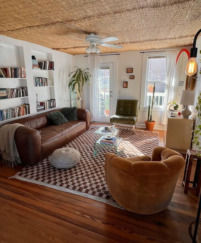 Bright living room with leather sofa and natural decor in cool interior design