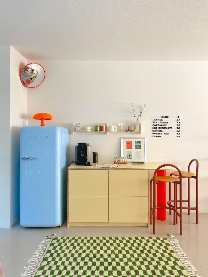 Modern kitchen corner with pastel fridge and coffee area in interior design