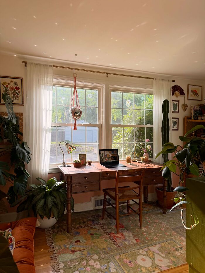 Sunlit vintage desk by window in warm cool interior design setup