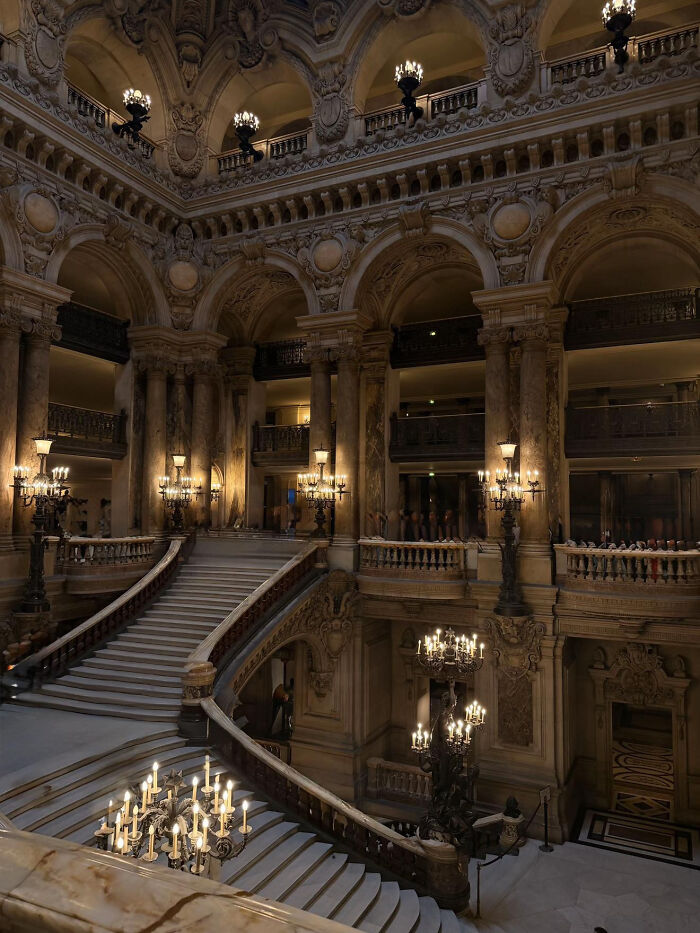 Aesthetic ornate staircase and lighting inside grand historic building