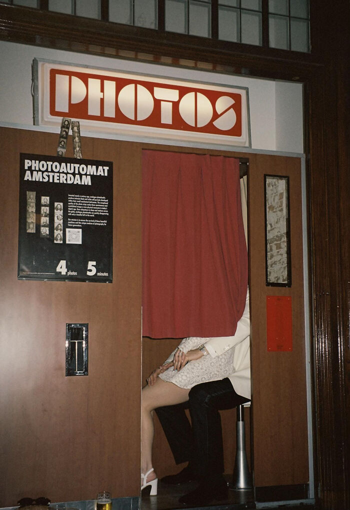 Vintage photo booth with couple partially visible inside in aesthetic photo setting