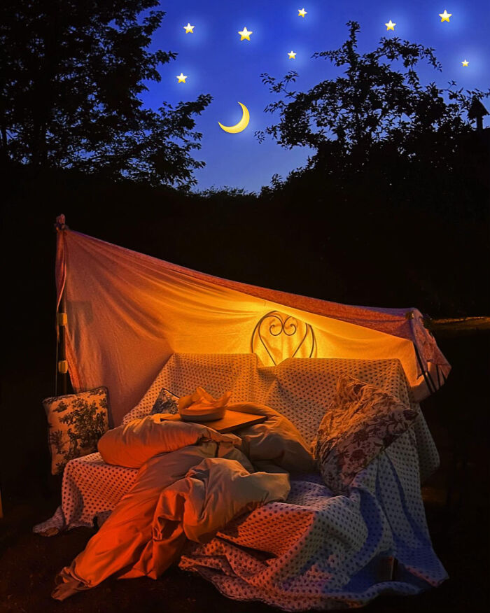 Aesthetic cozy outdoor blanket fort glowing at night with stars and crescent moon