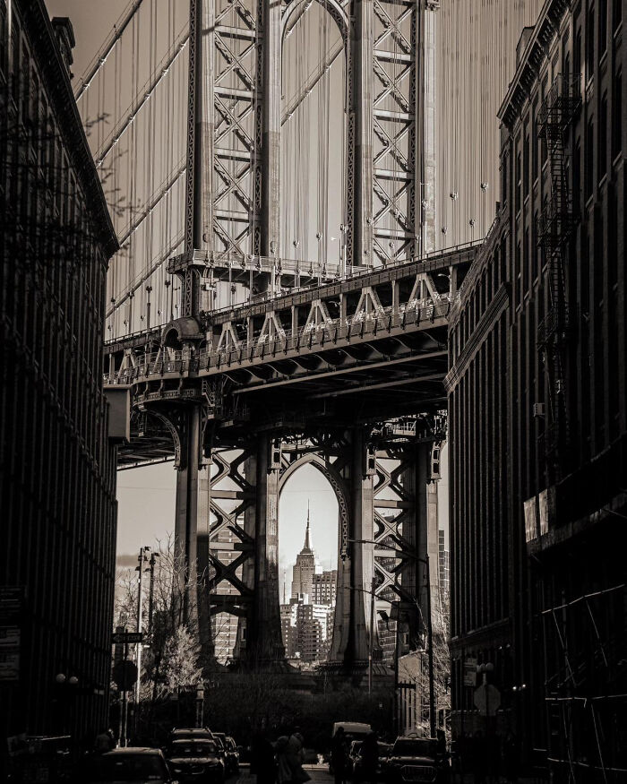 Aesthetic black and white urban bridge view with city skyline framed by steel structure