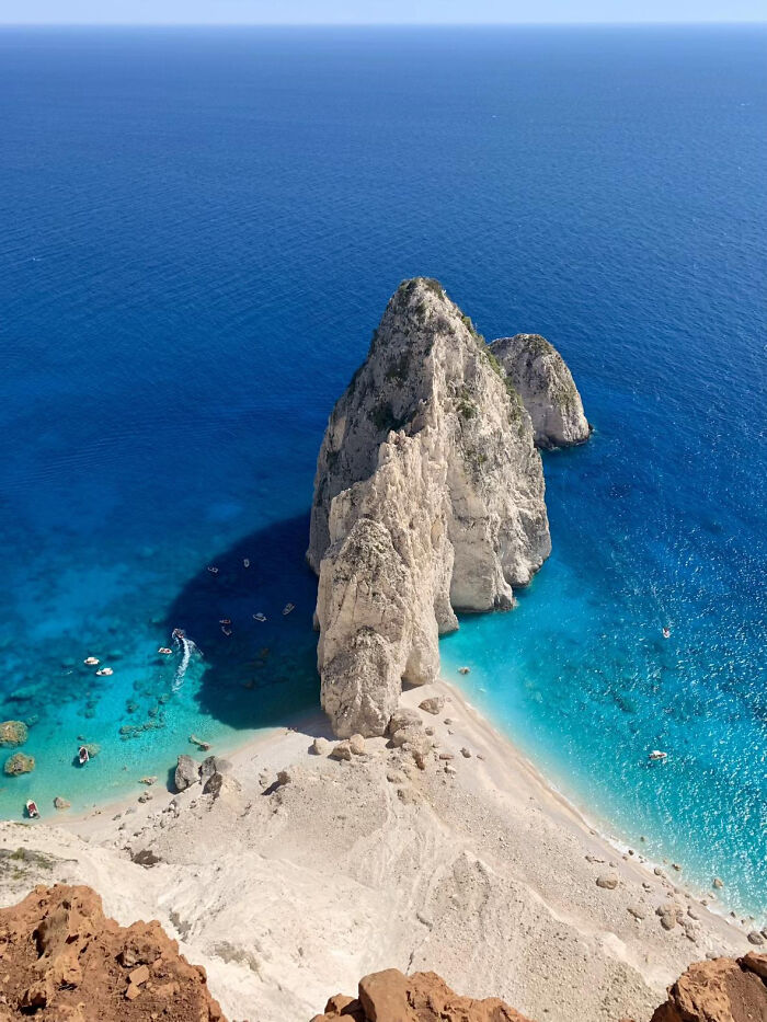 Aerial view of aesthetic beach with turquoise water and towering rock formations