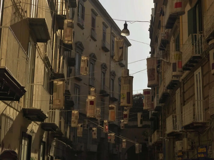 Aesthetic street with hanging lanterns creating a moody urban scene