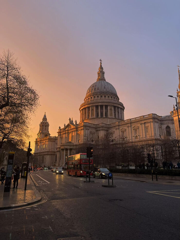 Aesthetic sunset view of classic architecture with a double-decker bus on a city street