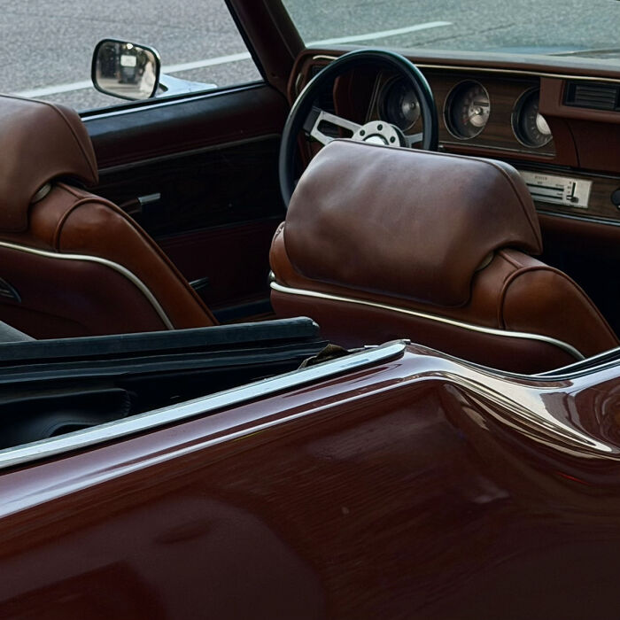 Aesthetic interior of vintage car with brown leather seats and steering wheel