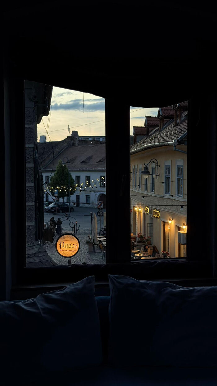 Cozy window view of restaurant on a quiet street at dusk