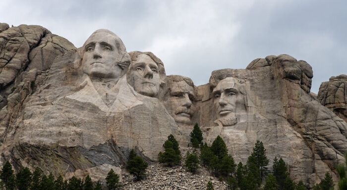 Mount Rushmore National Memorial featuring carved faces of US presidents including George Washington and Abraham Lincoln Mount Rushmore National Memorial featuring carved faces of US presidents including George Washington and Abraham Lincoln