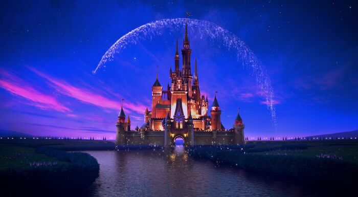Iconic Disney castle at night with fireworks arching over, symbolizing Disney magic and characters Iconic Disney castle at night with fireworks arching over, symbolizing Disney magic and characters