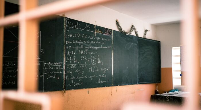 A classroom blackboard filled with arithmetic questions, evoking 8th-grade challenges and a bygone era of education. A classroom blackboard filled with arithmetic questions, evoking 8th-grade challenges and a bygone era of education.