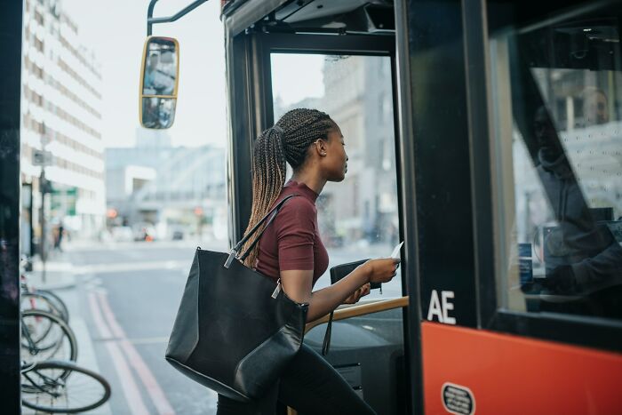 A person boarding a bus, potentially experiencing something creepy.