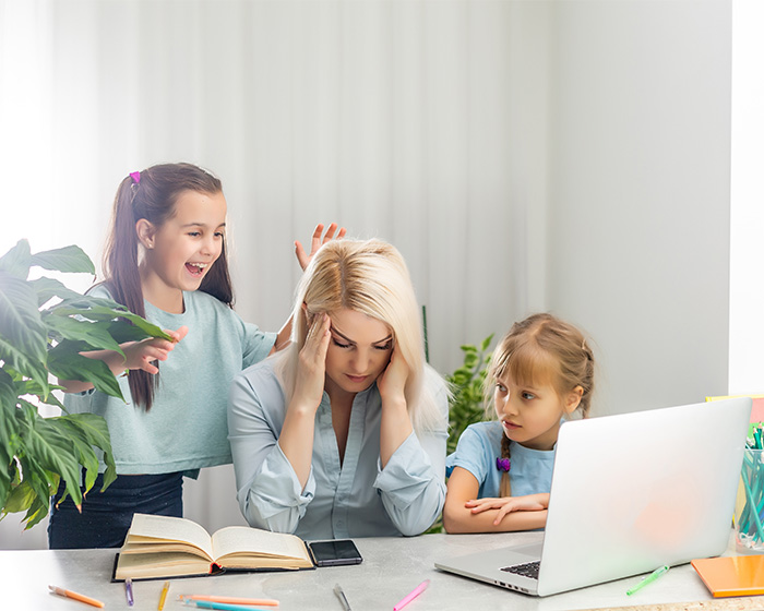 A stressed wife with two kids, one playing, one watching, showing the changes after having kids.