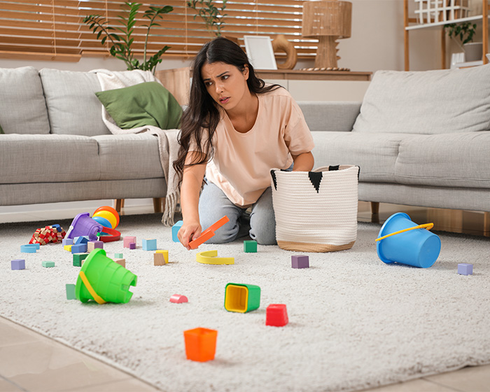 A tired mom cleaning up toys, a psychologist asked dads what their wives stopped doing after kids.